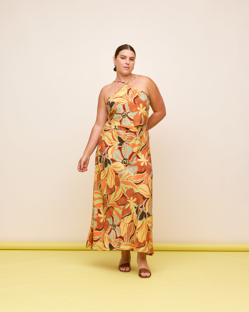 MELON TIE-BACK TOP MELON FLORAL | Cropped halter style top with a dipped hemline, that turns to reveal ties at the back. The shape of this top compliments the fun melon floral print. Make it a...