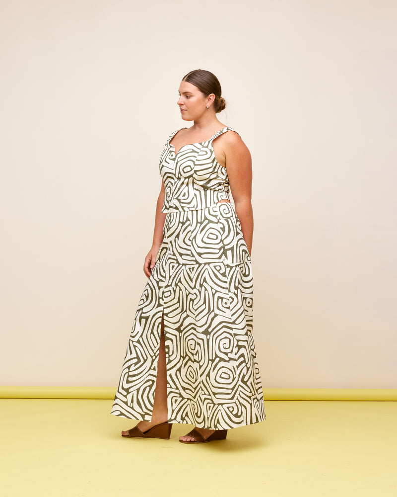 CECE SKIRT MAZE | A-line midi skirt designed in a khaki and cream maze print, printed on a mid-weight cotton drill fabric. This skirt has a front split and panel detailing. Make it a...