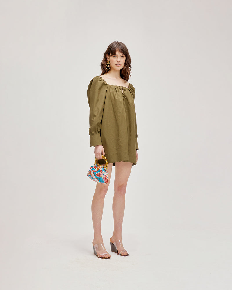 HERO MINIDRESS OLIVE | Cotton square neck minidress featuring a keyhole at the neckline, sleeve cuffs and slight A-line shape. The sleeves are elasticated at the shoulder for a subtle puff that gives shape to...