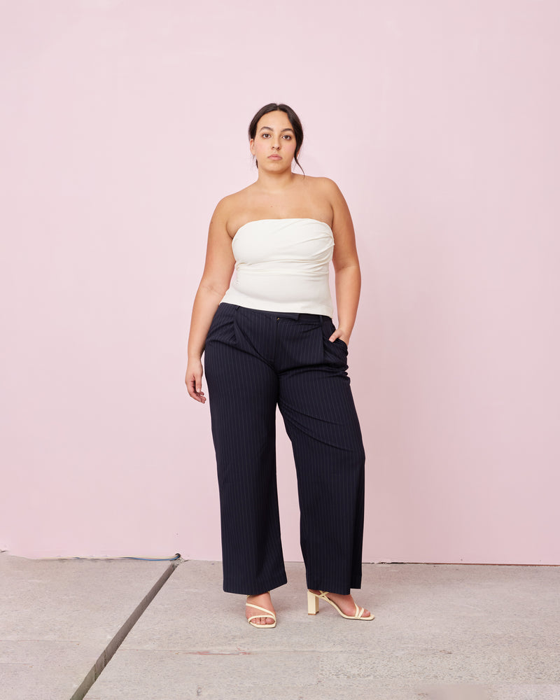RUE TROUSER NAVY PINSTRIPE | Straight leg mid-waist suit trouser with a flat waistband and belt loops. These pants are versatile in that they can we be worn casual with a baby tee, or formal with...