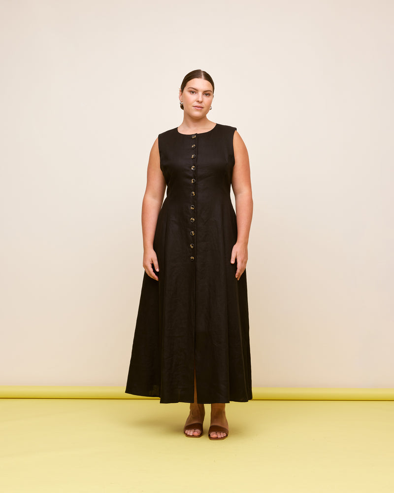 ALIZA LINEN DRESS BLACK | Sleeveless midi dress cut in a black linen. Featuring a round neckline with a button-down front, that finishes with a front split. This dress has waist ties to cinch it...
