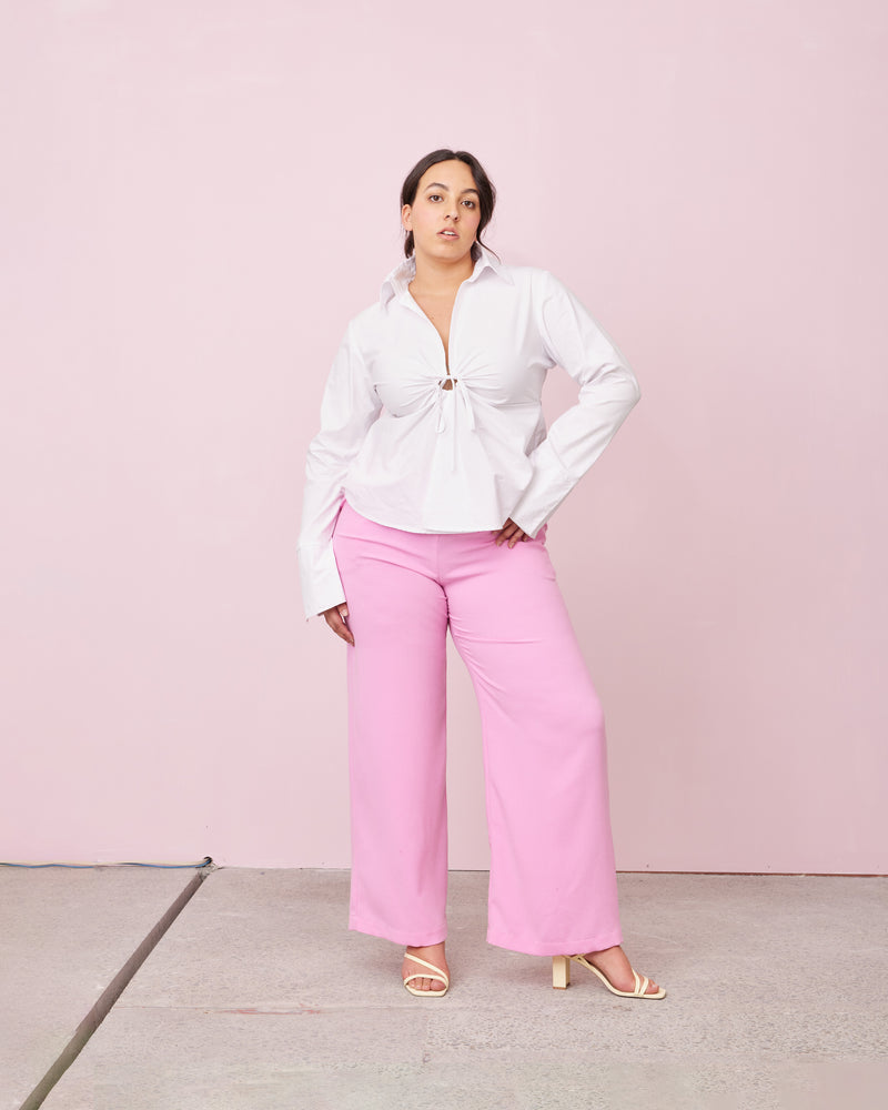 CALVIN TIE SHIRT WHITE | Cotton shirt with a feature drawstring keyhole at the bust, creating gathers fanning out across the shirt. The shirt has full length sleeves with a slight flared silhouette, created by splits...