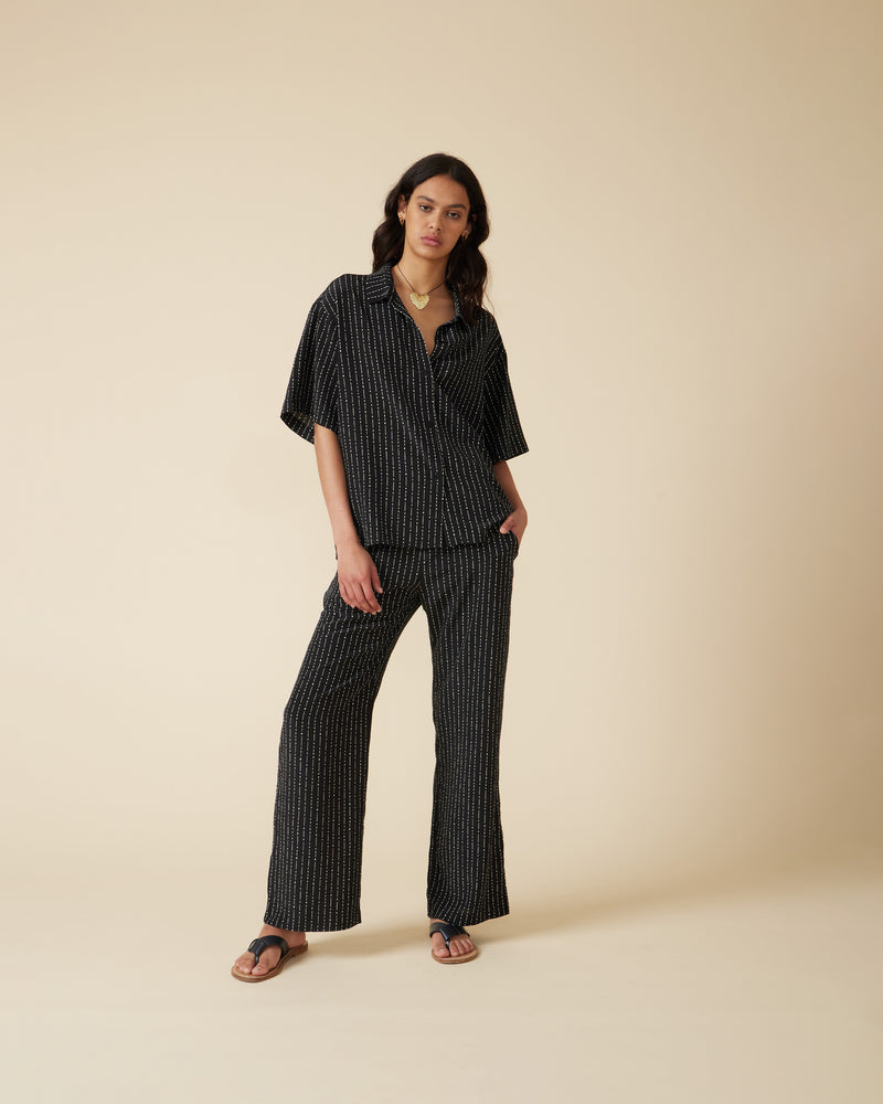 CAMERON SILK PANT BLACK BAMBOO | Relaxed low-waist pant designed in a slimky bamboo printed silk. Designed with an elastic waistband, these pants fit slouchy and can be matched with the Cameron Silk Shirt.