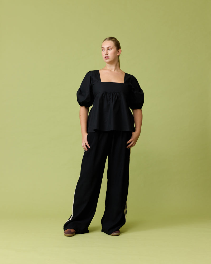 MARGIE TIE-BACK BLOUSE BLACK | Cotton puff sleeve top with a square band at the bust. Features a bow tie detail at the back and a cut-out, the cutest top worn with your favourite denim.