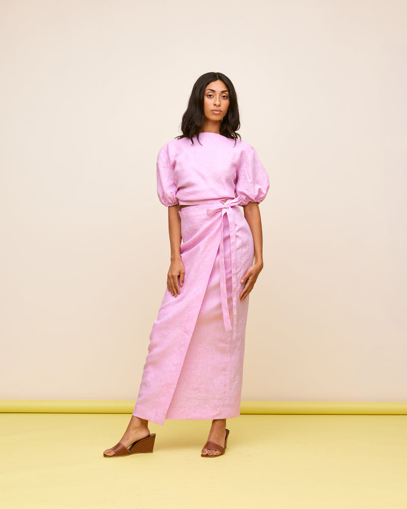 VIDA WRAP SKIRT PINK | Wrap skirt designed in a pink linen. This skirt is versatile in that it can be worn high or low-waisted. Make it a set by pairing this skirt with the...