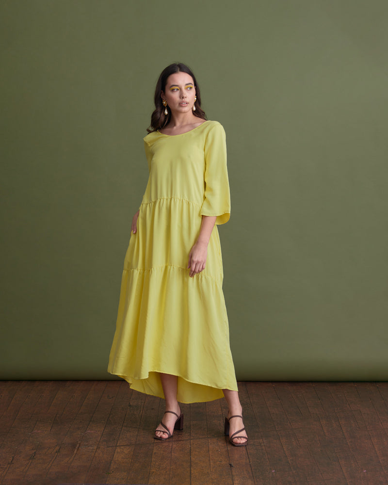 EROS MAXI DRESS LEMON | Full length loose fitting dress with slightly fluted elbow length sleeves and gathered panels on the skirt to create more fullness. This dress is reversible and can be worn with...