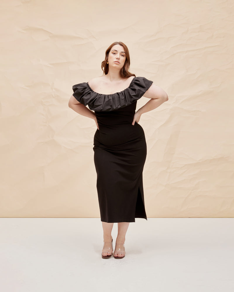 PARLOUR DRESS BLACK | Off shoulder slim fit dress with a feature frilled detail around the neckline, arm and back. The ruffle is designed in a cotton to emphasise the shape and the dress...