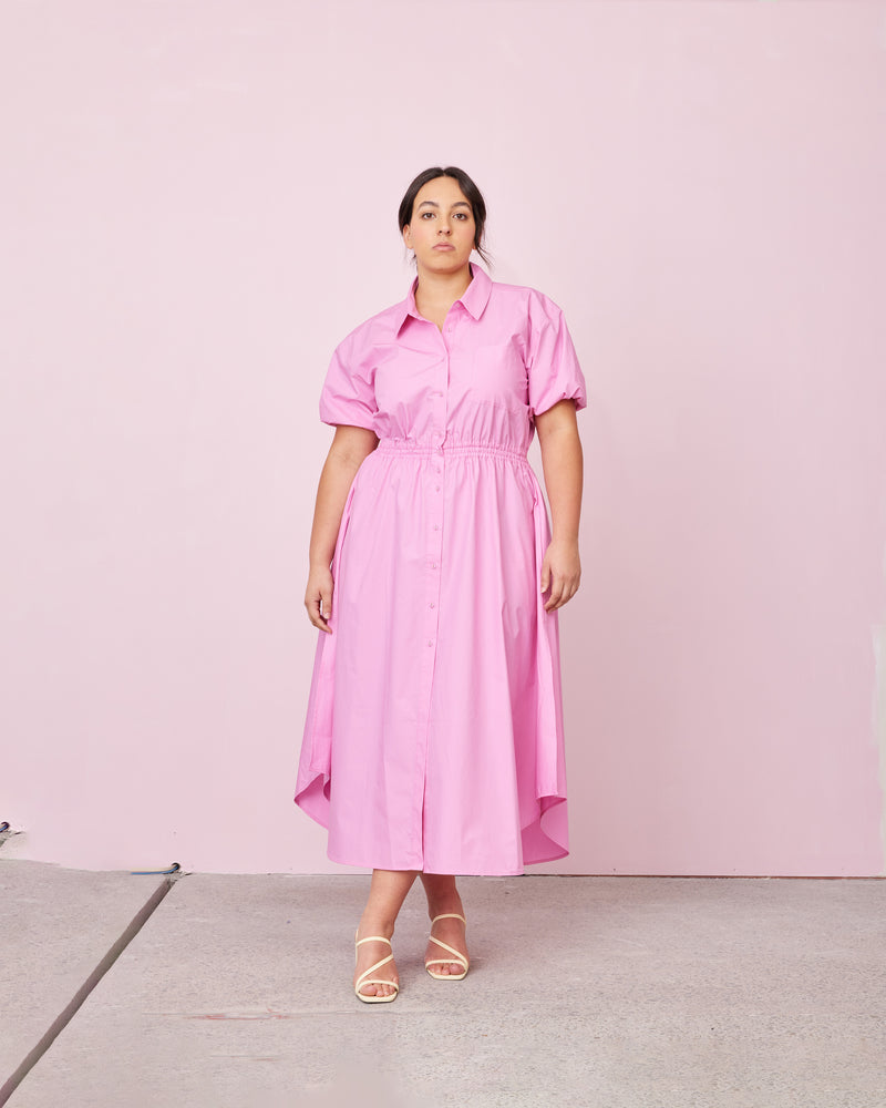 COMET SHIRT DRESS ORCHID | Maxi shirt dress crafted in a pink orchid cotton with an elasticated waist and short sleeves. The fully functional buttons allow you to show as little or as much skin...