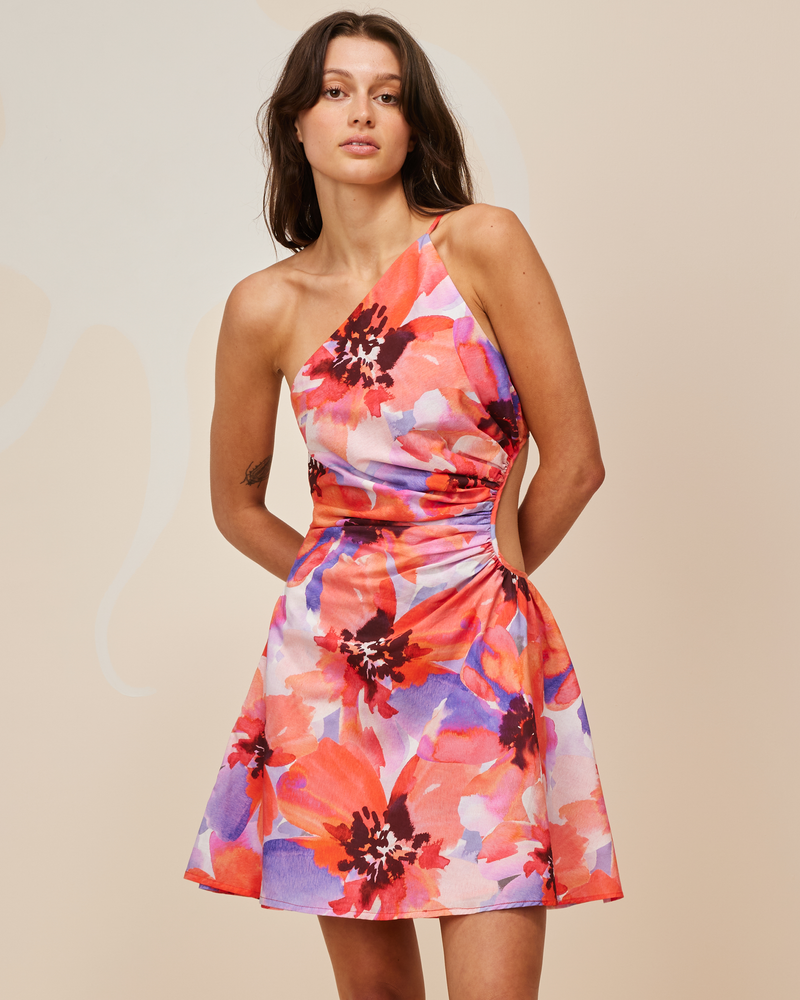 BETTINA CUT OUT MINI DRESS POPPY FLORAL | Asymmetrical one shoulder mini dress with a circular cut-out at the waist, designed in a striking red and purple poppy floral. This dress is designed to be a stand-out.