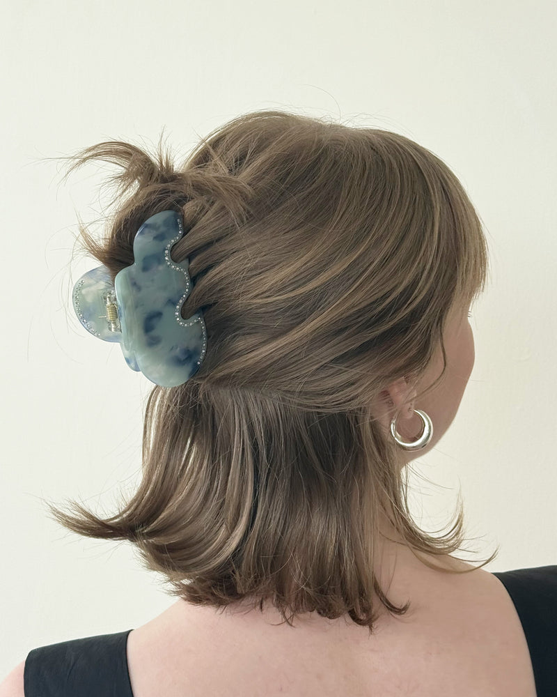 CLOUD SPARKLE HAIR CLAW SKY | Cloud-shaped hair claw in marbled blue colour with silver sparkle detailing. A fun take on a staple accessory, this hair claw holds half a head of hair and is comfortable...