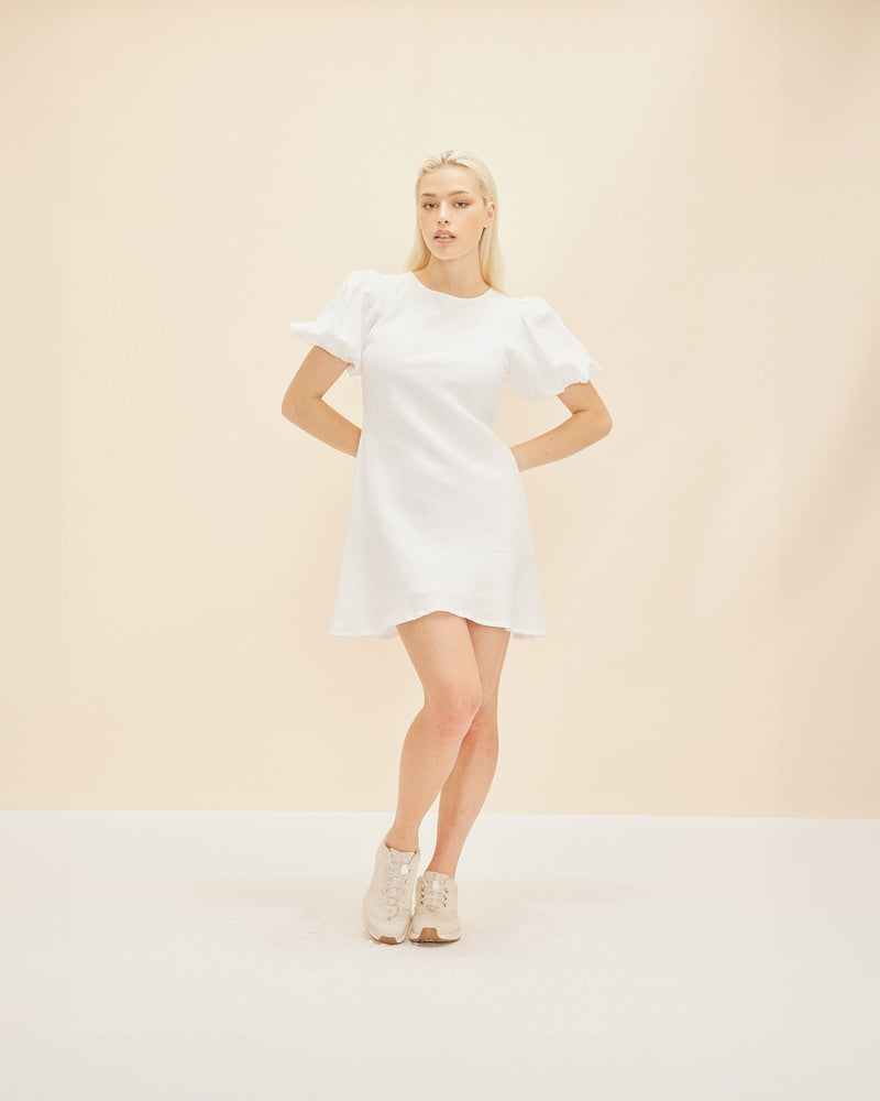 KENDALL LINEN MINI DRESS WHITE | Bias cut linen mini dress with puff sleeves and a keyhole button closure at the back neck. The bias silhouette of this dress gently contours the body, while the white...