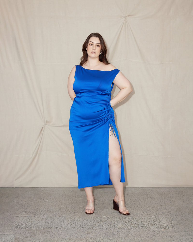 ERCOLINI MAXI DRESS BLUE | Maxi dress with a wide straight neckline and side split cut in a luxe textured cobalt fabric. Features a drawstring at the side seam that creates ruching across the body.