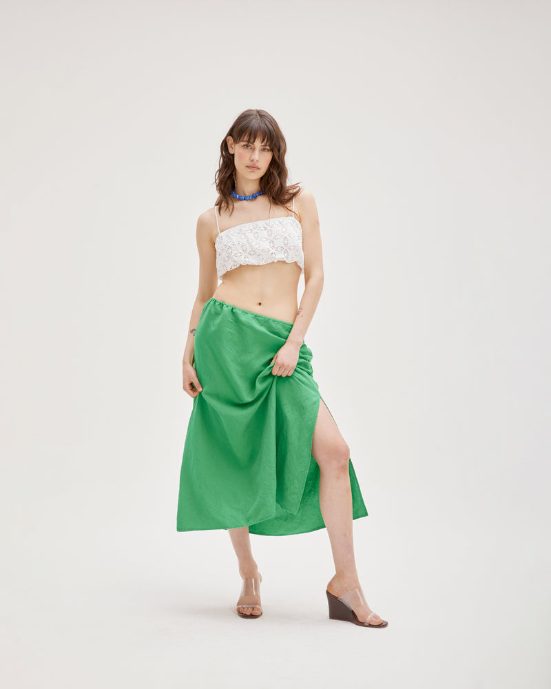 PARFAIT CROP WHITE | Broderie blouson crop featuring an elastic topline and hem with adjustable shoe lace straps. This piece is light and spirited in both its shape and fabric.