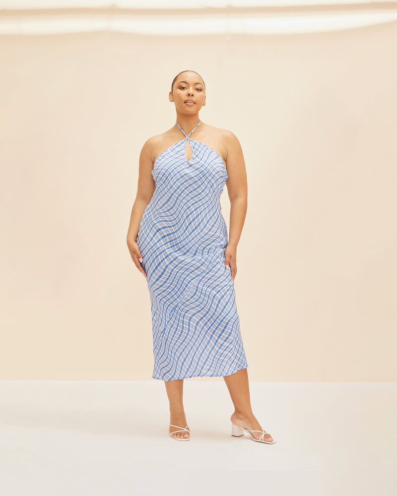 NEPTUNE SILK SLIP BLUE CHECK | Bias cut silk halter midi slip designed in our RUBY blue waves print featuring a keyhole front cut-out and back neck ties. The geometric print contrasts the floaty nature of...