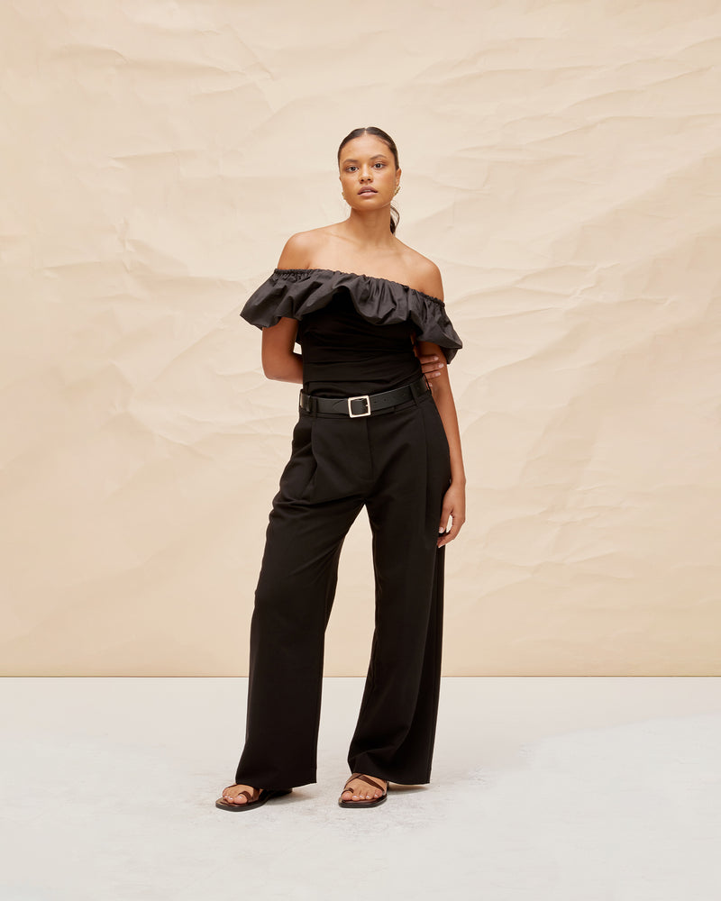 PARLOUR TOP BLACK | Off shoulder slim fit top with a feature frilled detail around the neckline, arm and back. The ruffle is designed in a cotton to emphasise the shape and the top is...