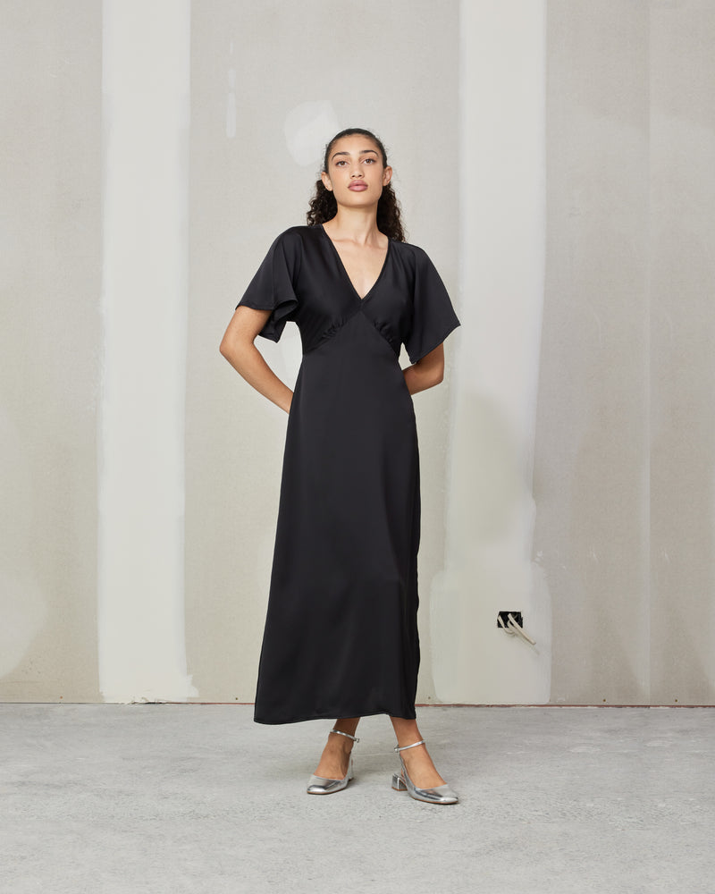 MATEA SATIN DRESS BLACK | Bias cut satin midi dress with a V-neckline and short floaty sleeves. Designed in a sheeny black satin, this dress is an update on our Uma Satin Dress with a...