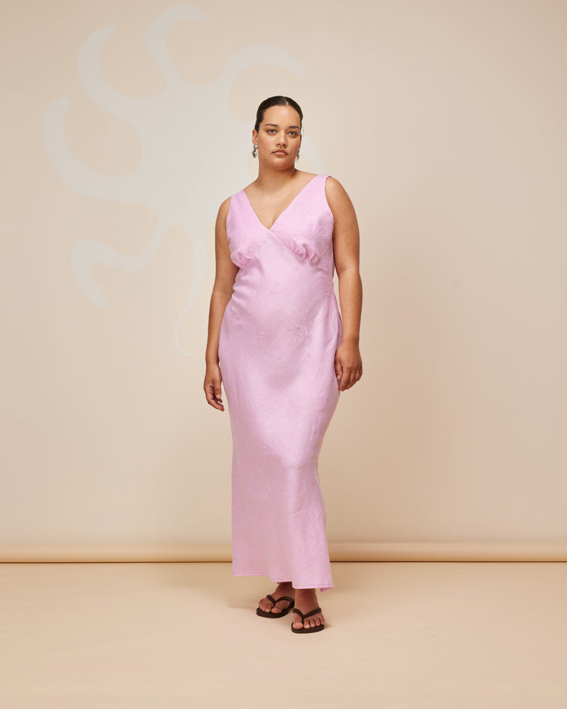 ESME LINEN SLIP DRESS PINK | Bias cut midi dress in a soft pink linen. Wide straps and a paneled V-neck front and back give this dress a vintage shape. Features a waist tie and side split...