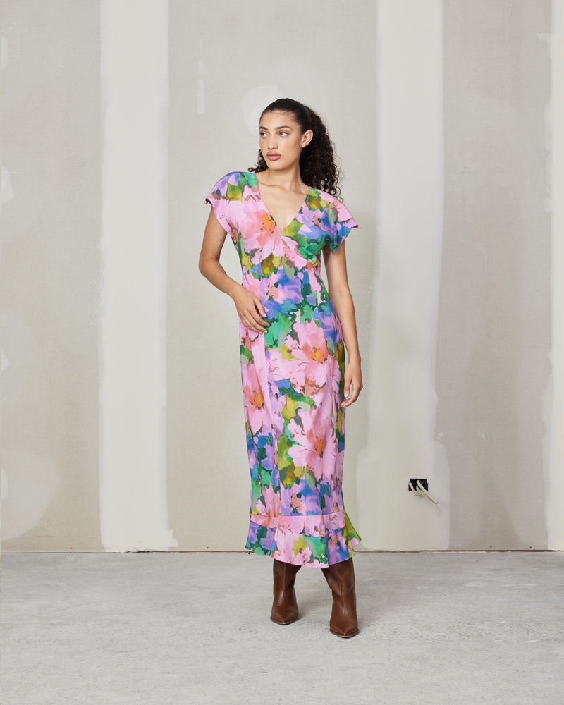 KATA SILK MIDI DRESS DREAM FLORAL | Bias cut midi dress with soft cap sleeves and a ruffled hem, crafted in a vibrant floral silk. The panelling in the dress creates a beautiful drape that compliments the...