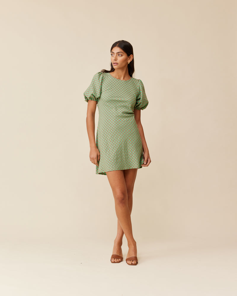 KENDALL GINGHAM MINIDRESS GREEN AND BROWN GINGHAM | Our iconic Kendall Minidress is back in a new green and brown gingham. Features a bias-cut with puff sleeves, and an open back secured by long ties at the back...