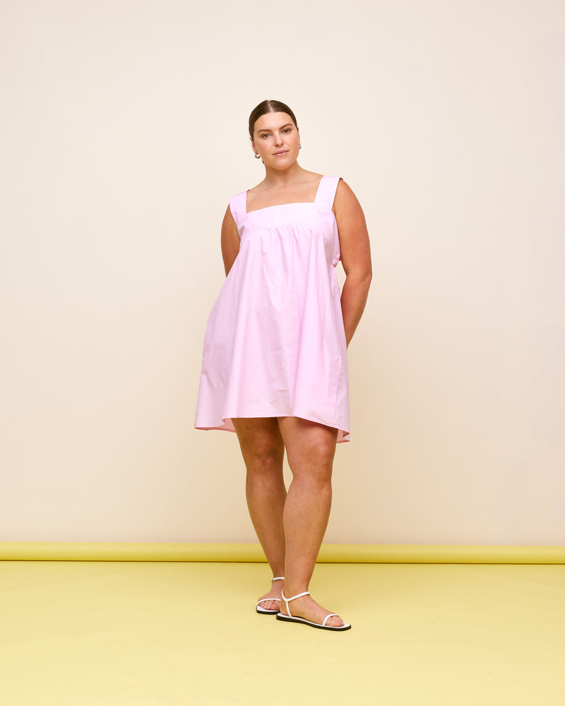 MARGIE TIE MINI DRESS PINK | Cotton mini dress with a square band bust. The skirt falls into an A-line shape with an exposed back and bow tie closure.
