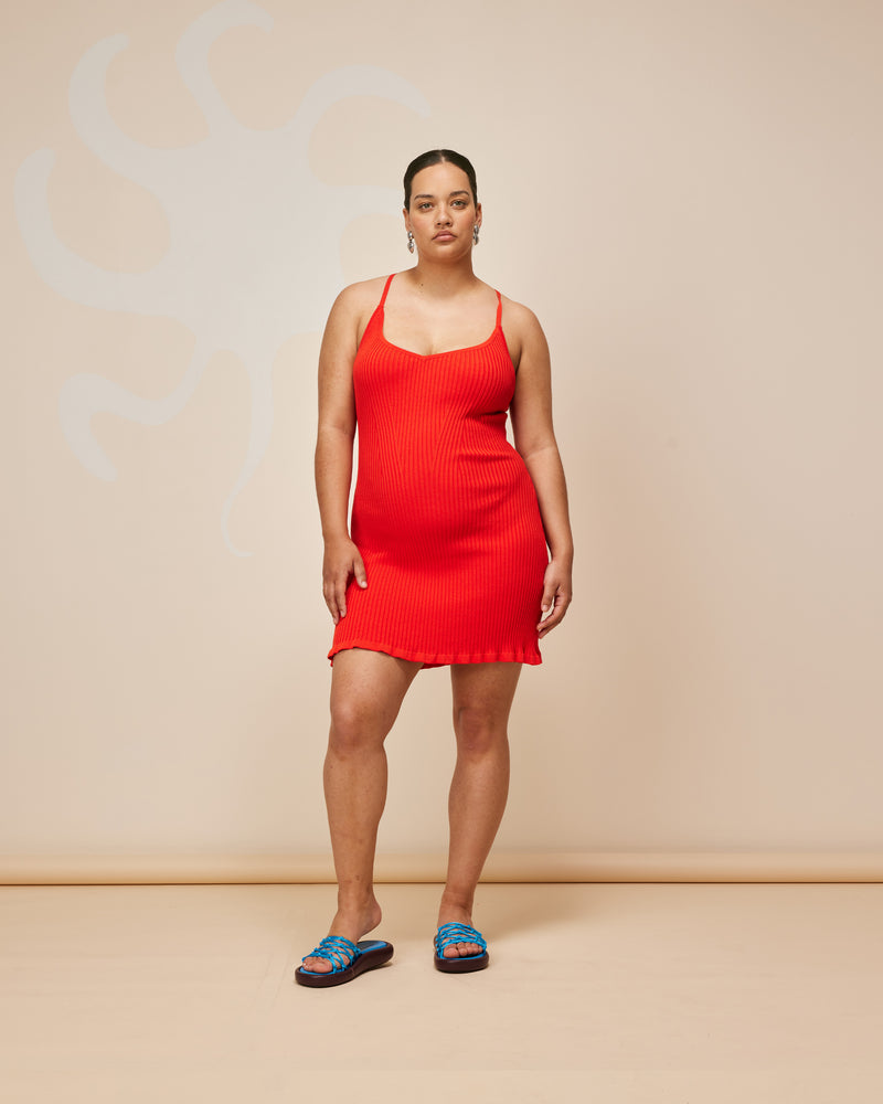 RINA MINI DRESS FRUIT PUNCH | Ribbed knitted mini dress designed in a vibrant fruit punch red. This staple dress can be worn many ways by adjusting the straps, giving you 4 options in 1.