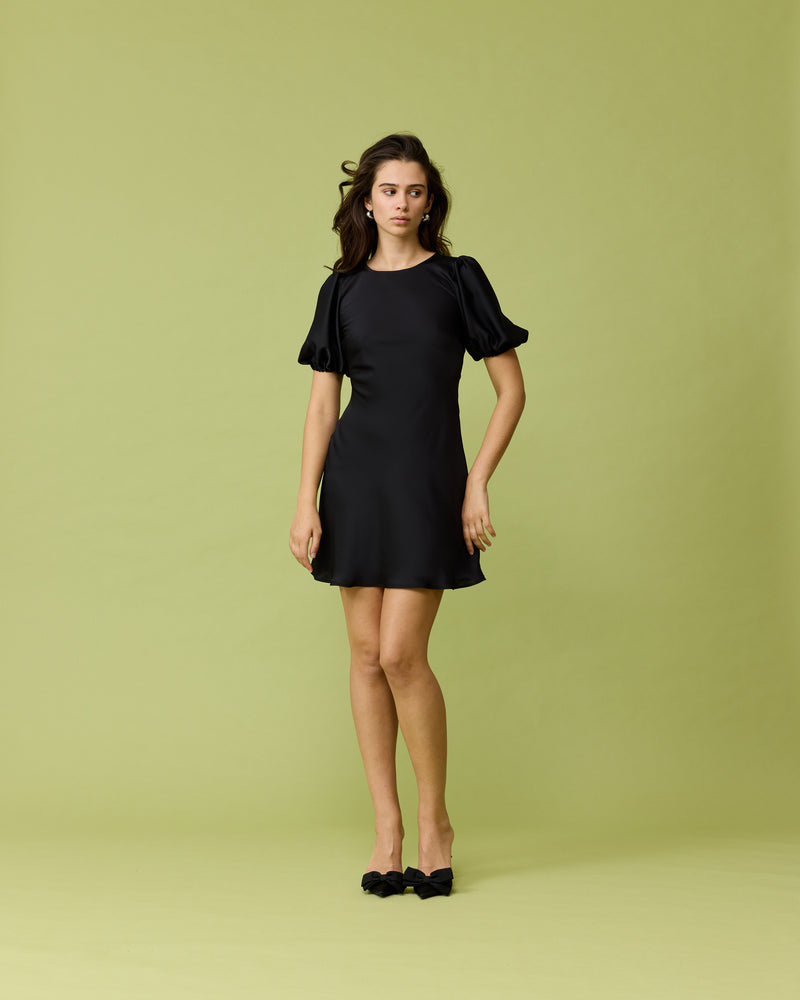 KENDALL SATIN MINI DRESS BLACK | Bias cut satin mini dress with puff sleeves and a keyhole button closure at the back neck. The bias silhouette of this dress gently contours the body.