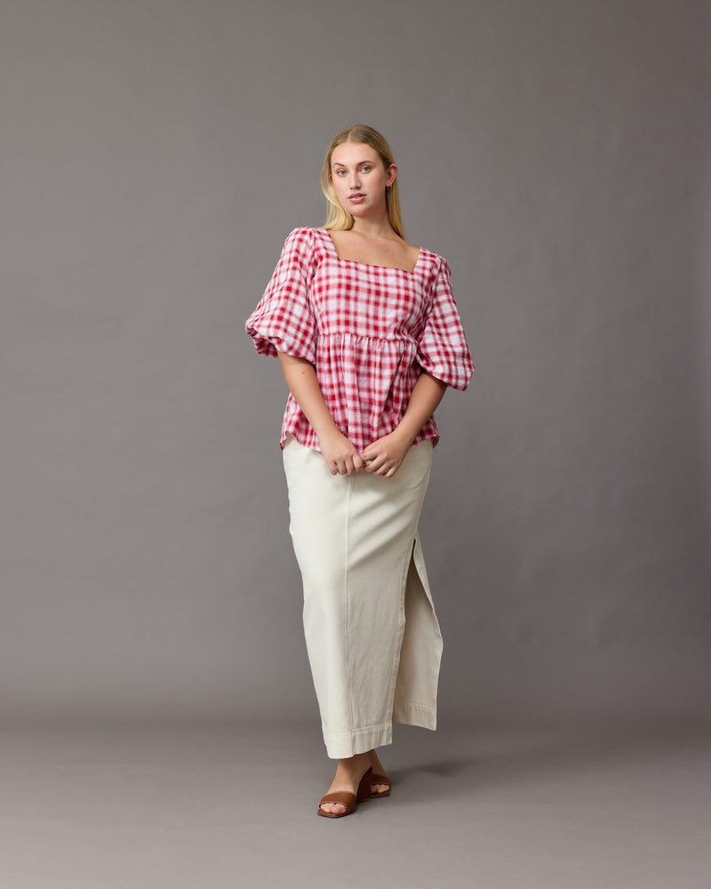 MOLLY BLOUSE RED CHECK | Cotton square neck blouse designed in a red check cotton with a subtle bubble texture. This blouse features a dropped waist that falls into a soft A-line tier, and 3/4...