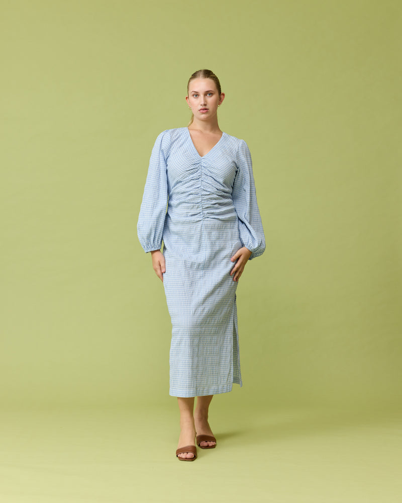 CANARY MIDI DRESS BLUE GINGHAM | Long sleeve midi dress with a V-neck designed in a blue check. This dress features a gathered seam down the centre front, that creates ruching around the body.
