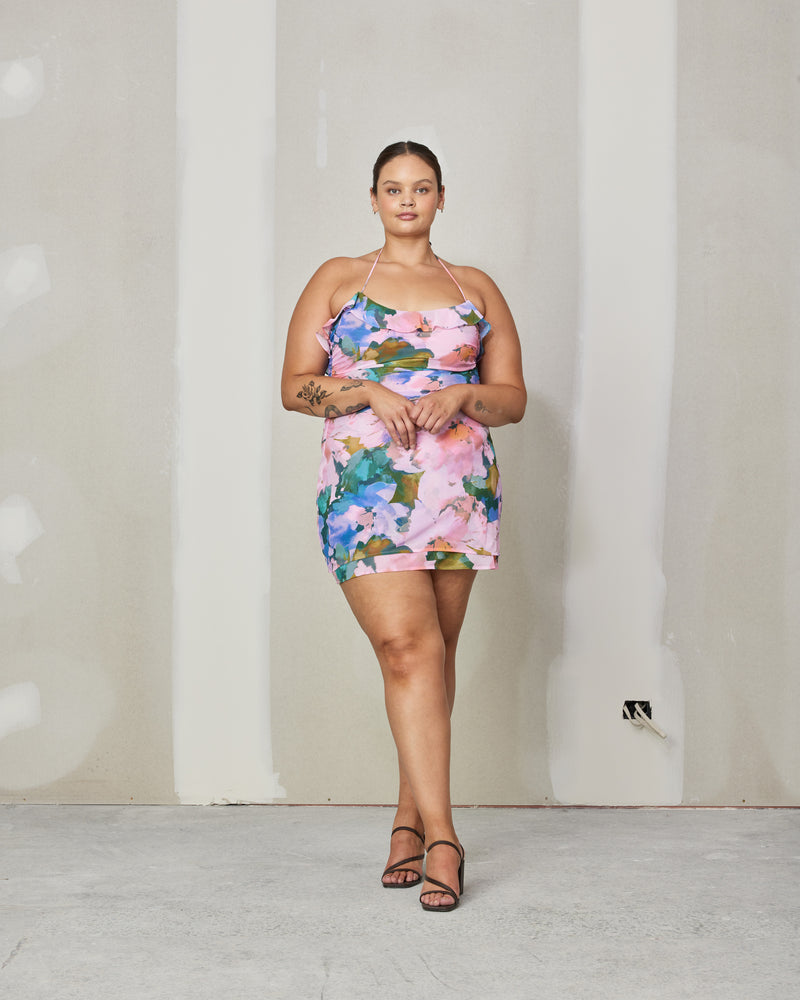 SENSE RUFFLE MINI DRESS DREAM FLORAL | Halter chiffon mini dress with ruffles down the middle and self covered buttons down the front in our dream floral print. The ruffle detailing along with the print gives this dress a romantic...