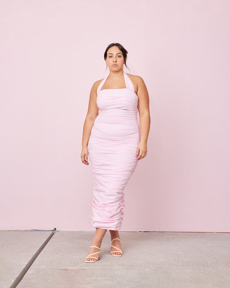ARIEL HALTER DRESS CARNATION | Crafted in a carnation pink cotton, this dress features a halter neck and ruching down the side seams for a pleated look throughout. 