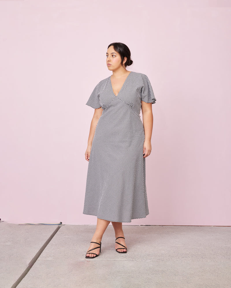 HONEY MIDI DRESS BLACK GINGHAM | V-neck midi dress, made in a lightweight cotton gingham. Fitted around the waist flowing to an A-line skirt, this dress is a timeless piece.