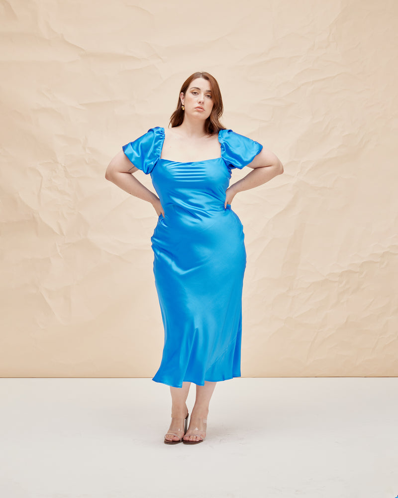 BOBBI SILK MIDI DRESS COBALT | Bias cut silk midi dress designed in a sheeny cobalt blue. Features a straight neckline and puff sleeves that compliment the vibrant blue shade.