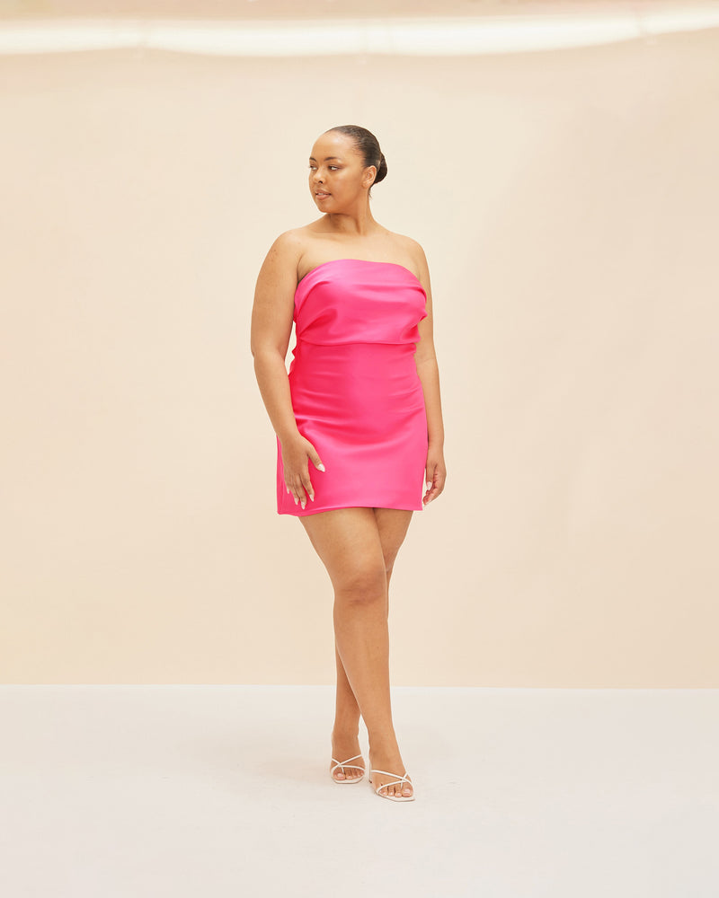 CHER SATIN MINIDRESS SUPER PINK | This minidress has a fitted bodice, with tucks crossing the bust, falling to mid-thigh. Cut in a super pink sheeny satin, enter the Cher Minidress.