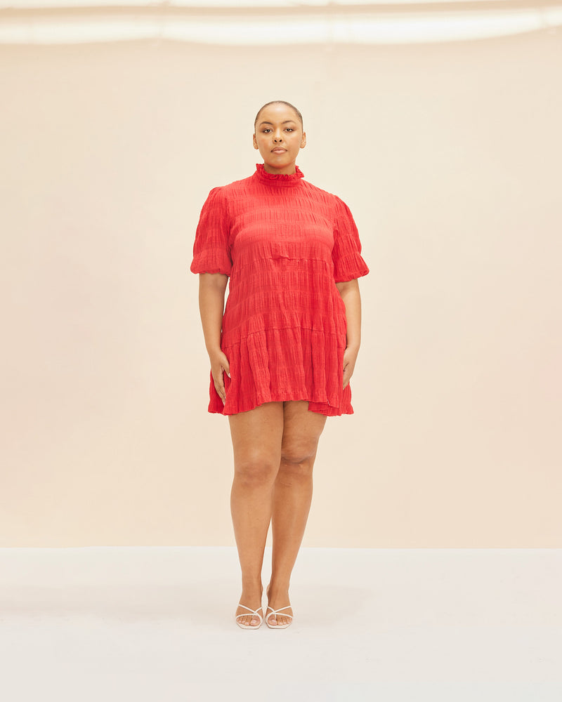 MIRELLA MINIDRESS CHILLI | T-shirt style minidress with short sleeves, an A-line silhouette and high-neck ruffled collar. The sleeves are elasticated at the hem creating a puff sleeve silhouette. Made in signature RUBY Mirella...