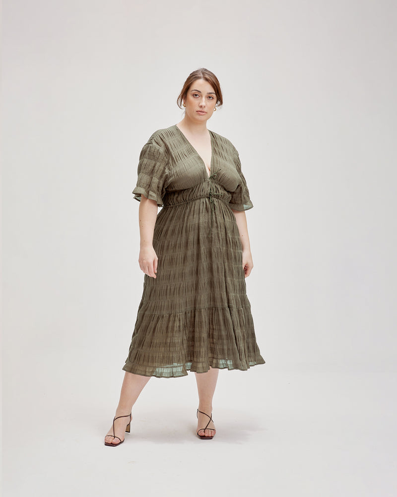 MIRELLA V-NECK DRESS OLIVE | Short sleeve midi dress with a deep V-neckline and a double drawstring waist in the signature Mirella fabric, a delicate embroidered cotton. A timeless silhouette appropriate for every occasion.