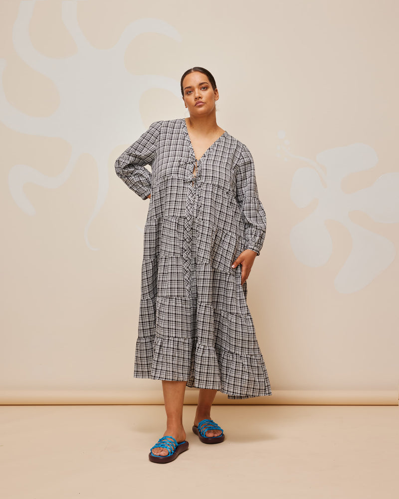 WREN TIERED MAXI DRESS BLACK CHECK | Longsleeve tiered maxi dress with V-neck and tie closure. Balloon sleeves and tiered ruching throughout the body gives this piece a floaty silhouette.