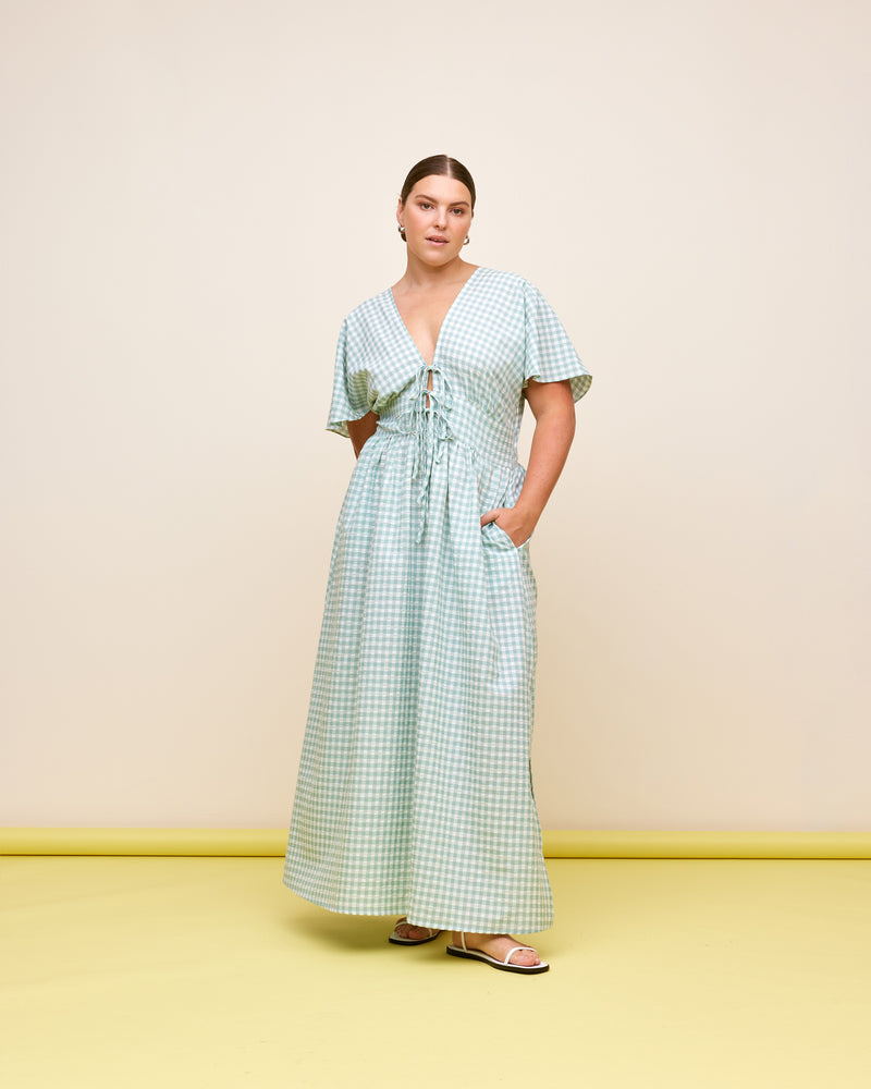 BENNY SHORT SLEEVE DRESS SAGE GINGHAM | V-neck midi dress that ties at the bust, made in a lightweight cotton gingham. Fitted around the waist flowing to an A-line skirt, this dress is a timeless piece.