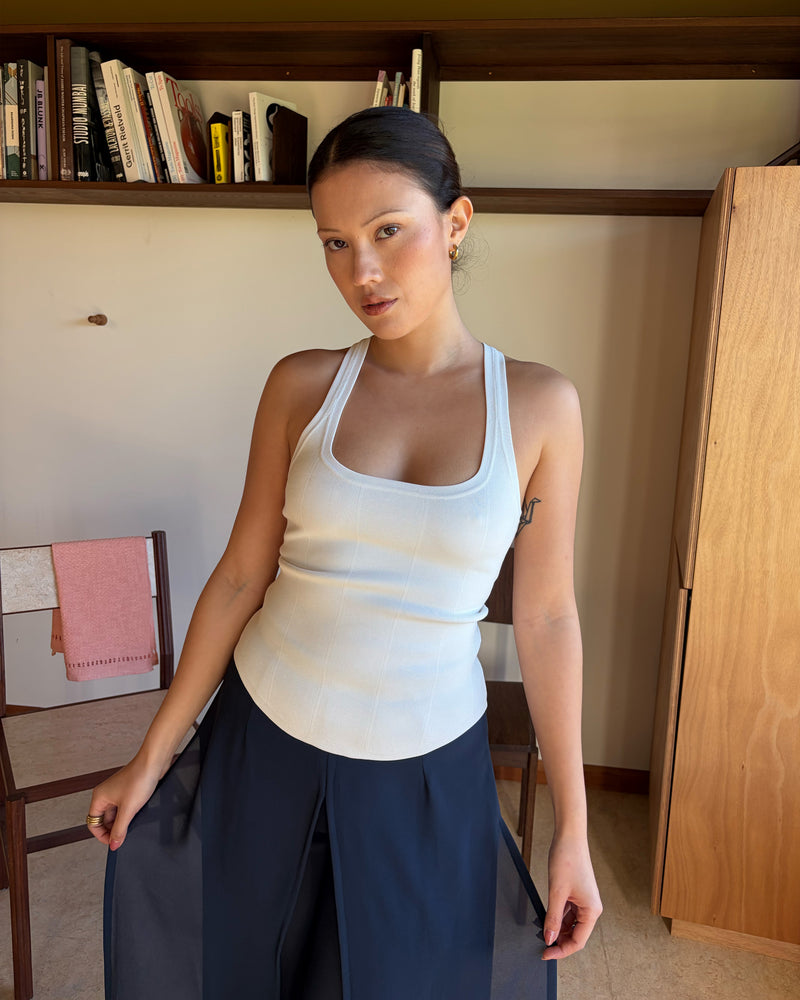 SOL TANK WHITE | A wardrobe staple for all year round, this classic racerback tank top is designed in a mid-weight white knit. Wear as a base layer under your winter favourites, or as an everyday go to during the warmer months. 