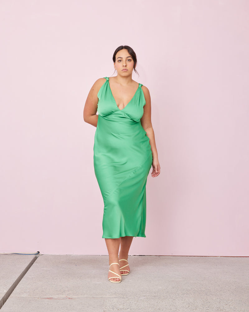 SUBLIME SATIN GOWN PARAKEET | 
Bias cut satin sleeveless gown with a plunge neckline and open back in a luxe parakeet shade. Features a knot detail at the shoulder and gathered detailing at the bust.