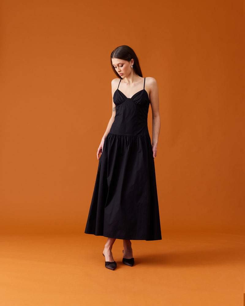 MONACO DRESS BLACK | Sleeveless midi sundress designed in a stretch black cotton. This dress features dainty straps and bust detailing, creating a sweetheart neckline. The dropped waist falls to a soft gathered midi...