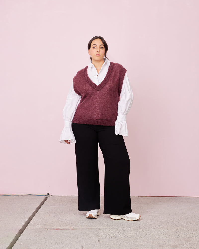 WATERMELON VEST PLUM | Oversized sleeveless sweater vest, made in a lightweight wool blend with ribbed hem details. This piece is perfect for playing with layering.