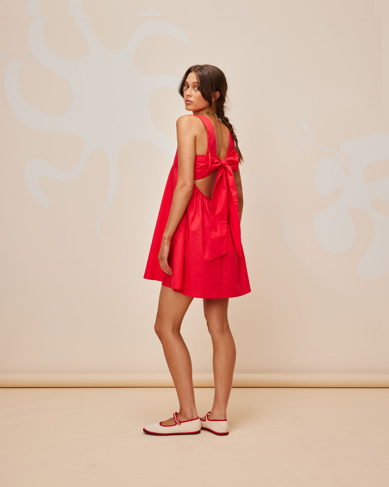 MARGIE TIE MINI DRESS CHERRY | Cotton mini dress with a square band bust. The skirt falls into an A-line shape with an exposed back and bow tie closure.