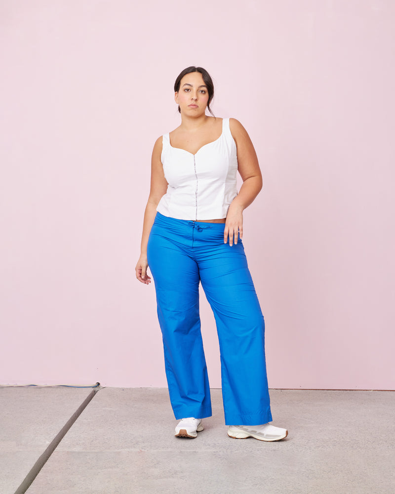 ARIEL BODICE WHITE | This piece features a flattering v-neck and a body-hugging silhouette, while a hint of spandex ensures a perfect fit. Hook-and-eye closures runs up the front which elevate this simple and timeless...