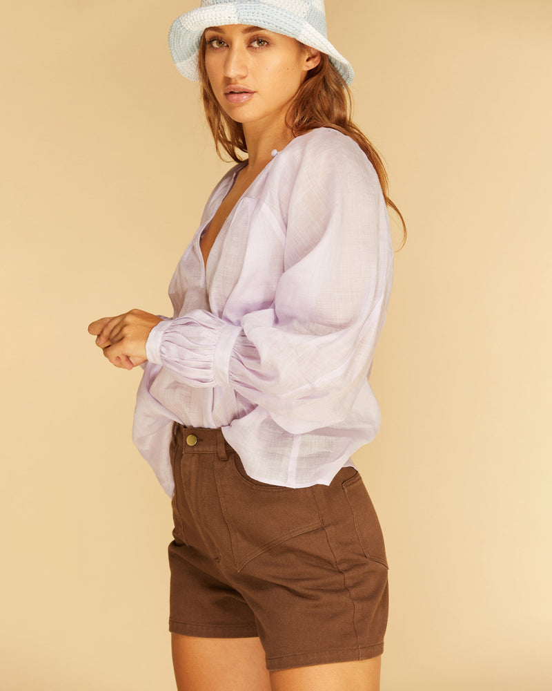 KAI BLOUSE LILAC | Oversized flowy blouse with self-covered button closure at the neckline, made from a delicate translucent ramie voile. Floaty in form, this blouse is a transeasonal staple.