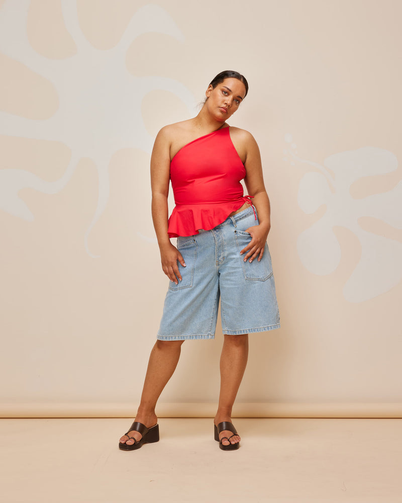 BETTINA COTTON TOP CHERRY | One shoulder cotton top with tie side gathering that can be cinched to adjust the length. The asymmetrical shape creates structure, while the peplum ruffle at the bottom hem adds...