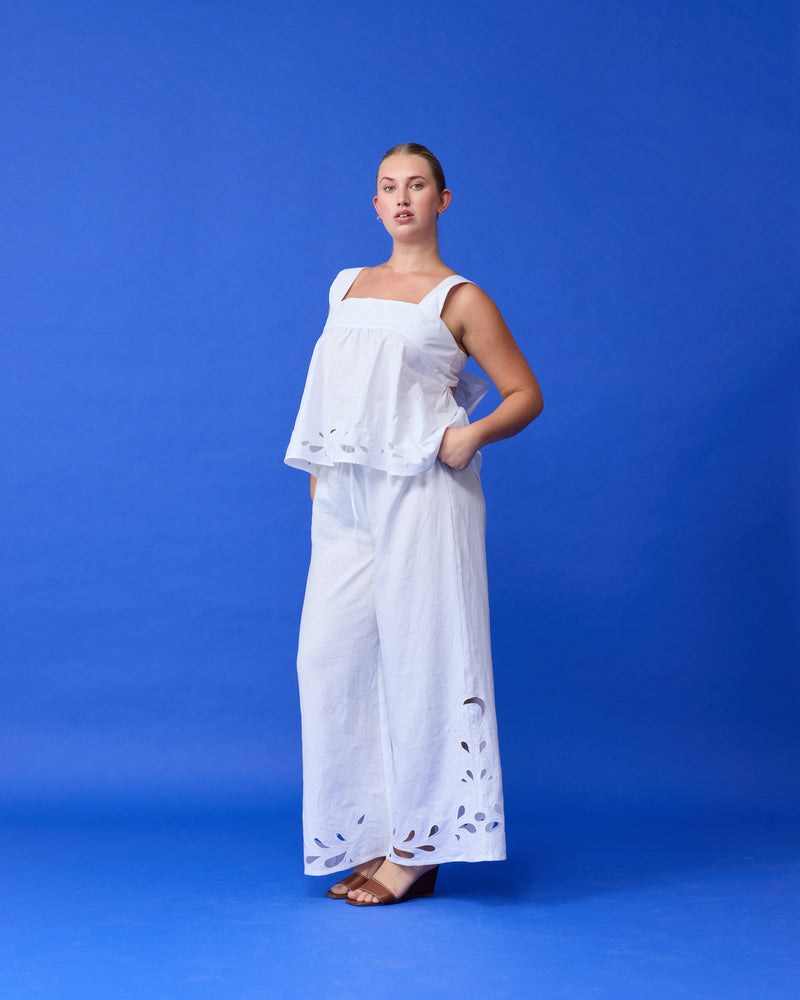 ANDIE LINEN PANT WHITE EMBROIDERY | Palazzo style elastic waist pants with a tie, in a light cotton with a feature broderie cut-outs at the hems. These pants are high waisted, uncomplicated and, classically cool. Make...