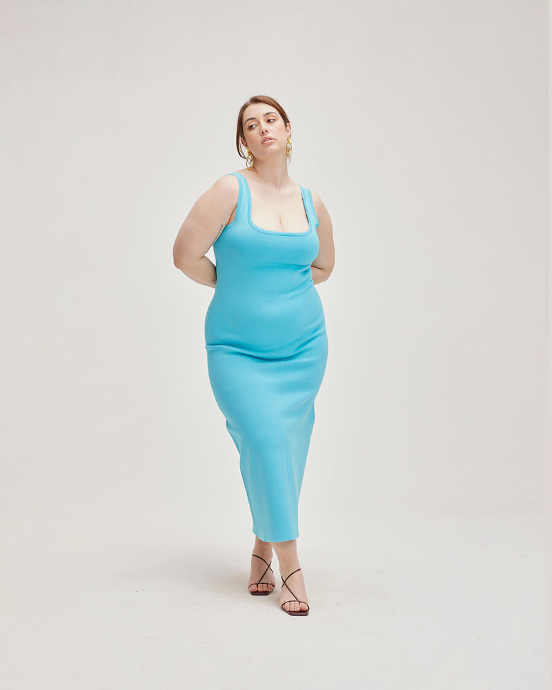 IMA DRESS AQUA | Sleeveless maxi dress with a square neckline and scallop edging throughout, made in a medium weight aqua coloured rib knit. Designed for a close fit that hugs you in all...