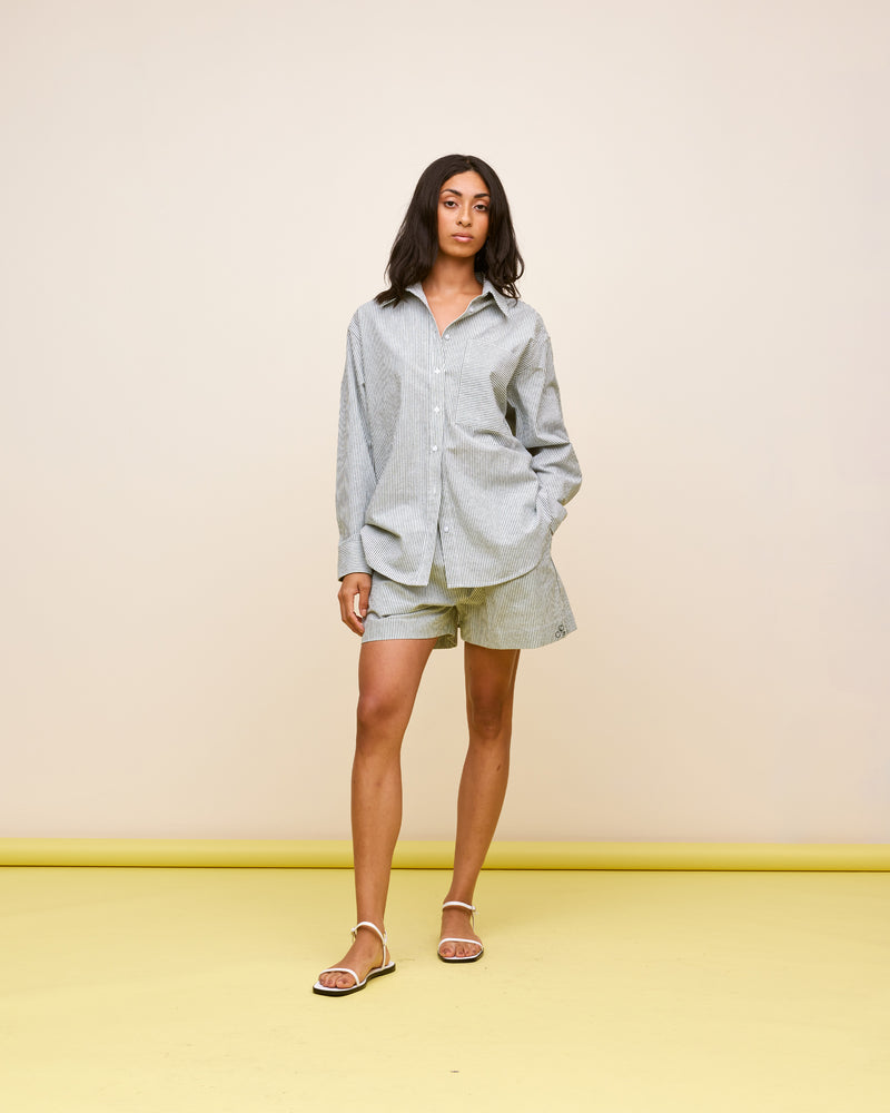 IDA SHIRT KHAKI STRIPE | Oversized crisp shirt with classic shirt detailing and a large contrast stripe pocket, designed in a khaki striped cotton. This piece is a timeless wardrobe staple that you will wear for years...