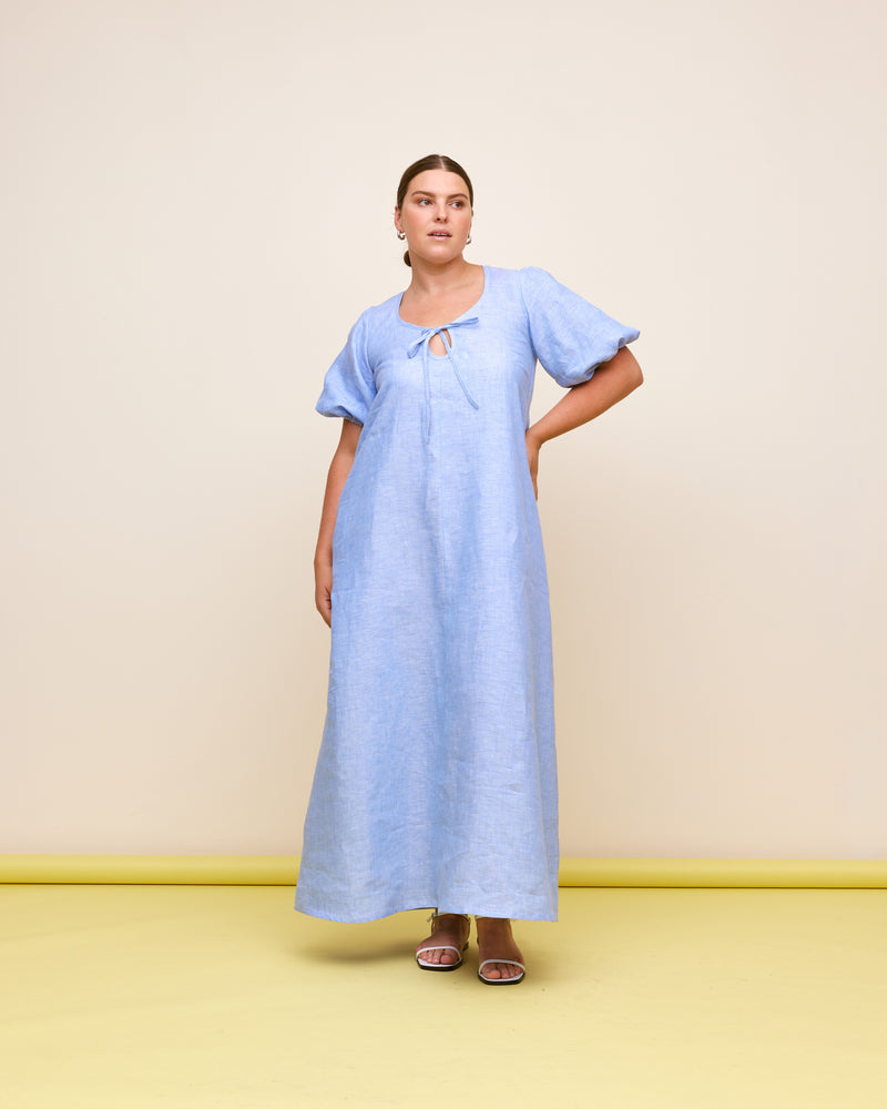 ANGEL LINEN MAXI DRESS BLUE MARLE | Relaxed fit maxi dress with elasticated puff sleeves and a tie neckline with a keyhole detail. Crafted in an airy linen, the puff sleeves add a romantic feel to this...