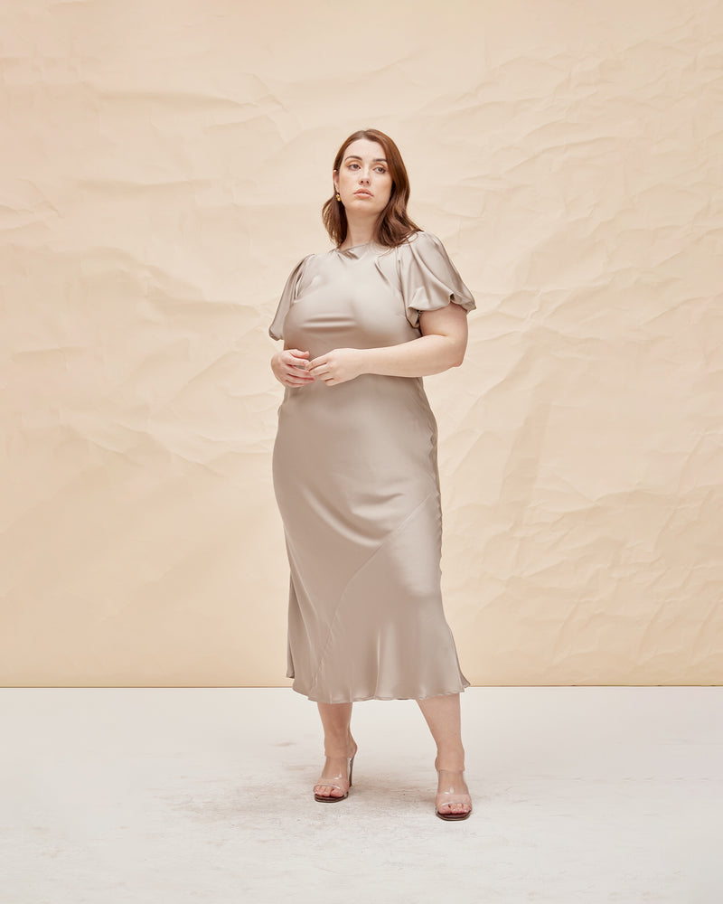 KENDALL SATIN DRESS MOONROCK | Bias cut satin midi dress with puff sleeves and a keyhole button closure at the back neck. The bias silhouette of this dress gently contours the body, while the moonrock...